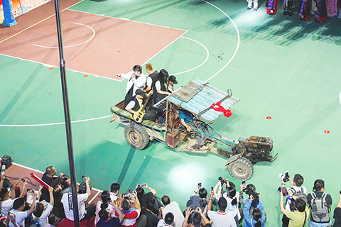 ◎ 「中國體育彩票杯」第九屆廣西萬村籃球賽總決賽在廣西玉林市興業縣蒲塘鎮啟幕,由廣西十四個地市產生的十四支冠軍隊伍將展開三十場精彩對決,上演為期三天的鄉村籃球盛宴。圖為開幕式現場,歌手乘拖拉機登場。(中新社記者 陳冠言 攝)